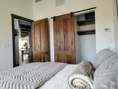 Three panel reclaimed oak doors one mounted as a sliding door, the second as a swing door.